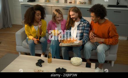 Food delivery service multiracial African Caucasian people friends diversity together gathering party man bring beer bottles pizza men women girls Stock Photo