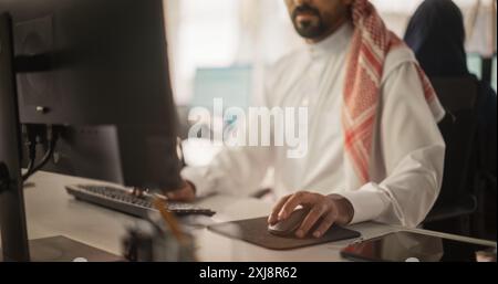 Close Up of a Arab Market Financial Analyst Working in a Research and Development Facility on a Desktop Computer. Middle Eastern Specialist Managing Corporate Investment Portfolio in Modern Office Stock Photo