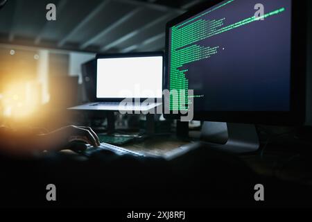 Hacker, night and person on computer coding for malware virus, online banking fraud and identity theft. Cybersecurity, software and thief on laptop Stock Photo