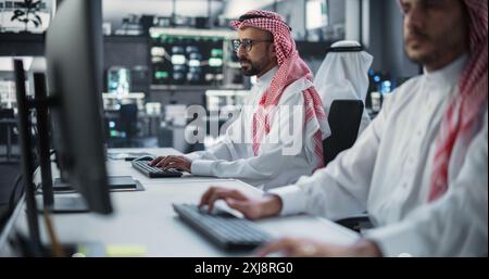 Two Young Middle Eastern Colleagues Working in a Cyber Security Software Development Department. Young Arab Manager Updating Software Developer on the Artificial Intelligence Safety Project Stock Photo