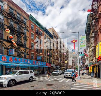 NYC Chinatown: Bayard Street, looking west from Elizabeth Street in the heart of Chinatown. Colorful paper lanterns hang above the shop-lined street. Stock Photo