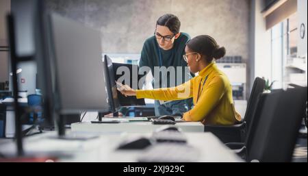 African Female and Caucasian Male Students Working Together in Infographics Class, Collaborating on a College Project. Diverse Scholars Talking, Study and Prepare for Computer Science Exams Stock Photo