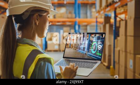 Futuristic Technology Warehouse: Female Worker Doing Inventory, Using Augmented Reality Program On Laptop Computer. Woman Analyzes Digitalized Products Delivery Infographics in Distribution Center. Stock Photo