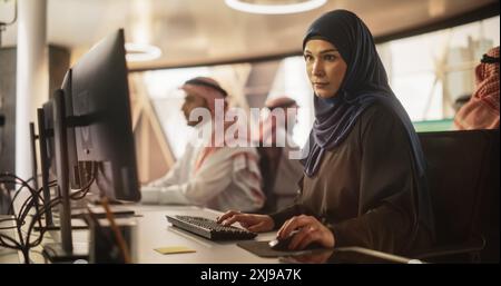 Portrait of a Young Muslim Female Working with a Talented Team of Male Professionals in a Technological Research and Development Agency. Group of Businesspeople Dealing with Financial Projects Stock Photo