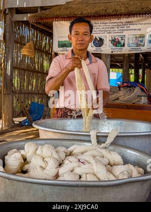 A man cleaning wool for dyeing in the small village of Angkor Ban, Battambang Province, Cambodia, Indochina, Southeast Asia, Asia Copyright: MichaelxN Stock Photo