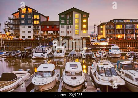 A dusk view of the marina harbour and adjacent apartments at Exmouth, east Devon, England, United Kingdom, Europe Copyright: NigelxHicks 1202-840 Stock Photo