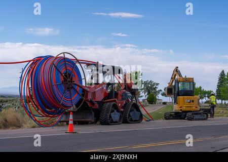 Machinery for installing plastic conduit for internet fiber optic cable underground in rural Utah. Stock Photo