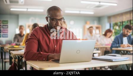 Adult Education Center: African Student Learning in Classroom, Using Laptop to Write Down Notes. Group of People Taking a Workshop on Improving Their Professional Work Skills. Stock Photo