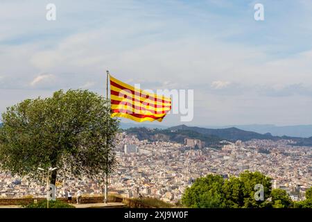 Catalan flag flies over the Montjuic Castle old military fortress on Montjuic Mountain overlooking the city, Barcelona, Catalonia, Spain, Europe Copyr Stock Photo