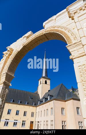 Europe, Luxembourg, Luxembourg City, Church of Saint John in Grund and the Neimënster Cultural Centre framed by Reproduction of ancient Stone Archway Stock Photo