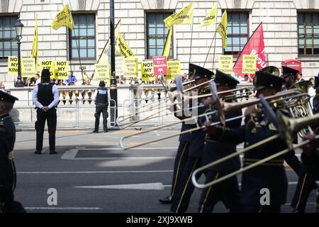 Anti-royalists line the road of Whitehall with banners and placards saying ‘Not my King’ and Labour for A republic’ ahead of King Charles and Queen Camilla attending the opening of Parliament. London, United Kingdom. 17th July 2024. Stock Photo