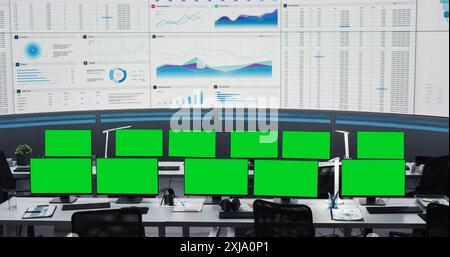 Empty Monitoring Office With Green Screen Chromakey Desktop Computer Monitors Of Employees. Big Digital Screens Showing Graphs And Charts. Mockup Template Of Successful Financial Analytics Company. Stock Photo