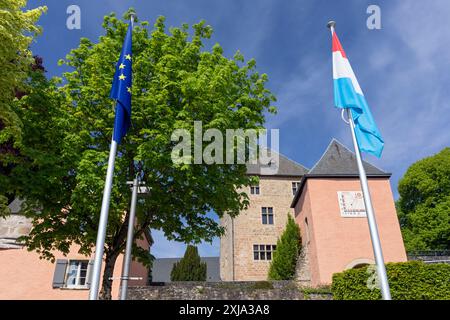 Europe, Luxembourg, Mersch, Mersch Castle (Château de Mersch) with Flags of the EU and Luxembourg Stock Photo