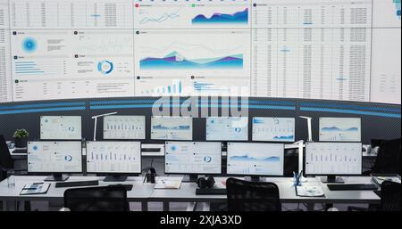 Empty Modern Monitoring Office With Big Digital Screen And Working Places of Employees With Desktop Computers and Monitors. Graphs And Charts Showing Financial Data And Reports Of Consulting Company. Stock Photo