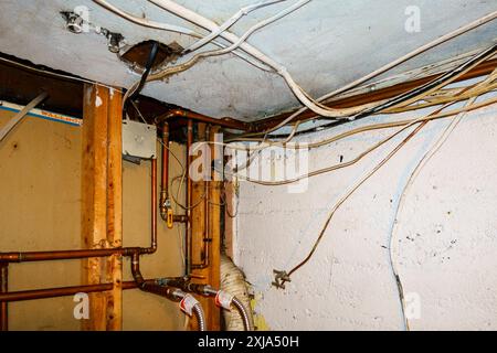 Exposed home electrical wires in basement. Stock Photo