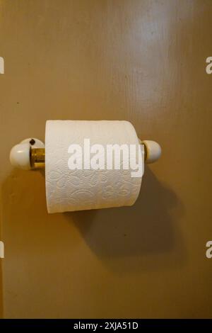 Toilet roll holder with new roll of toilet paper Stock Photo