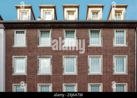 Modern Brick Building Facade with Windows and Dormers Stock Photo