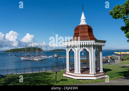 Gazebo in Bar Harbor Maine with sailing ship in harbor Stock Photo