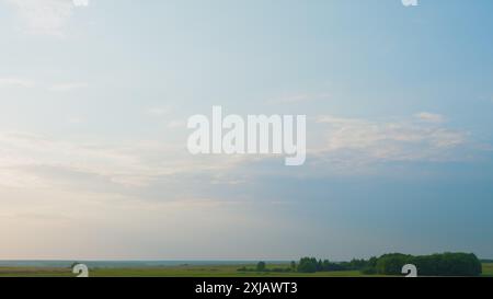 Time lapse. Fluffy curly rolling cloud in windy Summer weather. White clouds background. Stock Photo