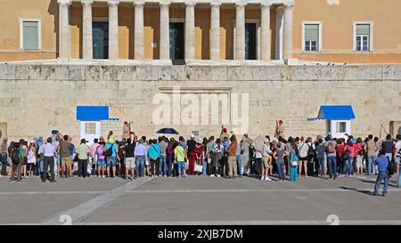 Athens, Greece - May 04, 2015: Crowd of Tourists Watching Changing Guards Ceremony in Front of Hellenic Parliament Building in Capital City Centre Sun Stock Photo