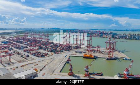 GUANGZHOU, CHINA - JULY 13, 2024 - Cargo ships load and unload cargo at ...