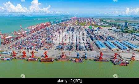 GUANGZHOU, CHINA - JULY 13, 2024 - Cargo ships load and unload cargo at ...