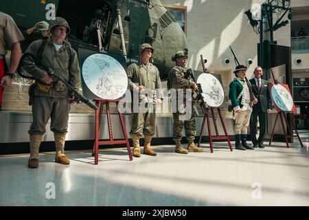 U.S. Marine reenactors pose for a photo after the U.S. Mint unveiling of the new trio of commemorative coins dedicated to the 250-year anniversary of the U.S. Marine Corps at the National Museum of the Marine Corps, Virginia, July 17, 2024. The coins are a testament to the courage, sacrifice and dedication of all Marines, ensuring that their stories will be remembered and celebrated. (U.S. Marine Corps photo by Lance Cpl. Joaquin Dela Torre) Stock Photo