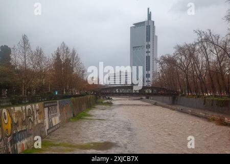 Torre Telefonica modern skyscraper and a historic wood bridge over Mapocho River Parque de los Reyes, Santiago de Chile Stock Photo