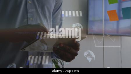Image of statistical data processing against mid section of a man using tablet at office Stock Photo