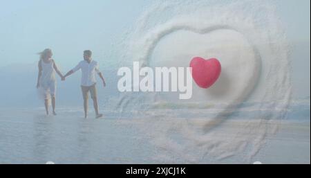 Image of hearts over happy diverse couple holding hands on beach by sea Stock Photo