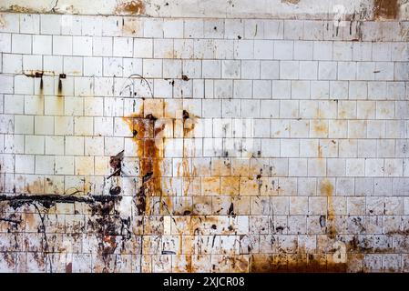 Background Of An Old Dirty Rusty Tiled Wall In Industrial Interior Stock Photo