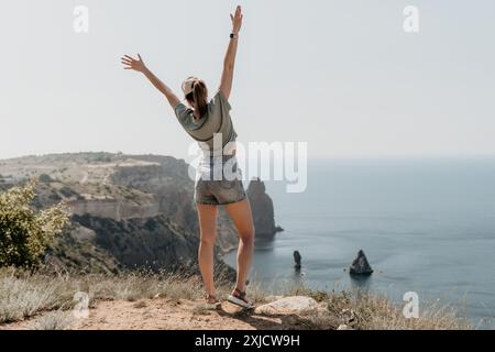 Woman Celebrating Freedom on Clifftop Stock Photo