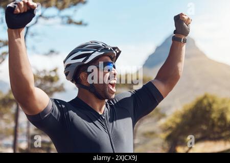 Happy man, cyclist and celebration with helmet in nature for challenge, winning or victory on mountain. Excited male person, athlete or biker with Stock Photo