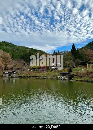 Traditional Japanese houses and thatched roof huts by green fields ...