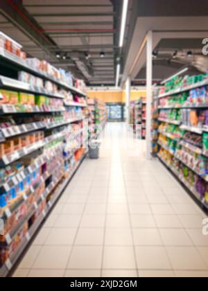 Supermarket aisle with colorful shelves. Abstract blur as background. Stock Photo
