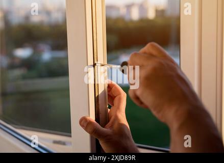 adjustment of windows by the craftsman from the window specialist Stock Photo