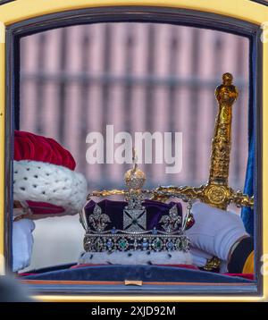 Westminster, London, UK. 17th July, 2024. King Charles III attends the State Opening of Parliament and presents The King’s Speech, formally marking the new session of Parliament. The historic ceremony is surrounded by pomp, tradition and colour. The Imperial State Crown together with the Great Sword of State and the Cap of Maintenance travel to Parliament by coach. Credit: Malcolm Park/Alamy Stock Photo