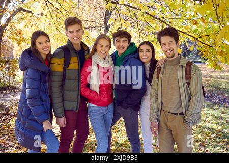 Group of friends pose in an autumn park. Stock Photo