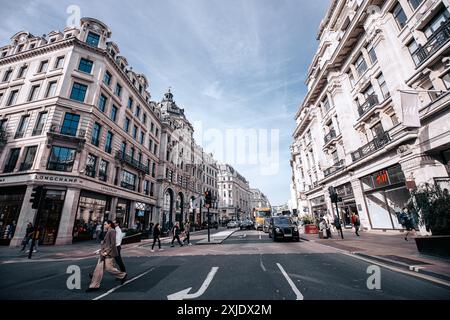 London, UK - October 10, 2023 : A bustling street scene in London, UK, with Regent Street lined by grand buildings and busy pedestrians. A black taxi Stock Photo