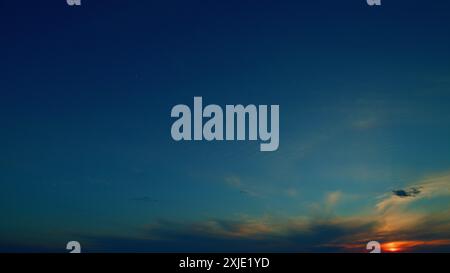 Time lapse. Sun halo is visible as cirrus clouds form in the sky. Gradient color. Stock Photo
