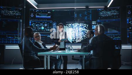 Chief Software Engineer Conducting a Quality Assessment Meeting With His Artificial Intelligence Design Team. Group of Developers Discussing Possible Development of a New Advanced Neural Network Stock Photo