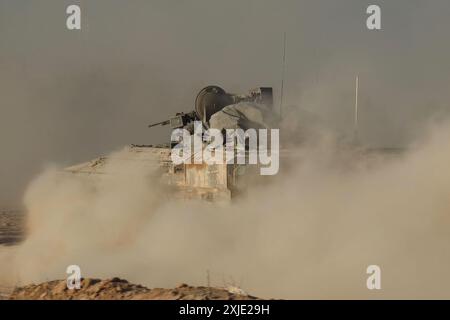 GAZA BORDER, ISRAEL - JULY 17: An Israeli military armored vehicle makes its way to southern Gaza, amid continuing battles between Israel and the militant group Hamas, on July 17, 2024 in Israel at the Gaza Strip border. Stock Photo