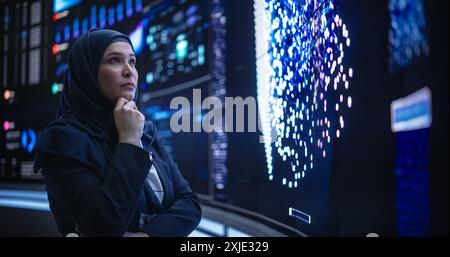 Portrait of a Thoughtful Middle Eastern Software Developer Working in Technological Corporate Office. Young Woman Testing Artificial Intelligence Algorithms for an Innovative Internet Project Stock Photo