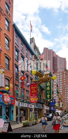 NYC Chinatown: Dueling flags – American, Taiwanese, and Chinese flags fly from neighboring buildings on narrow Pell Street, in the heart of Chinatown. Stock Photo