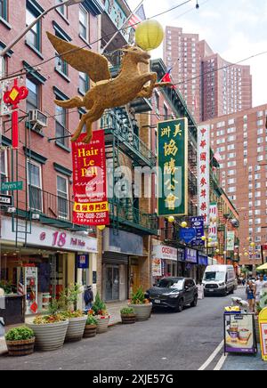NYC Chinatown: Dueling flags – American, Taiwanese, and Chinese flags fly from neighboring buildings on narrow Pell Street, in the heart of Chinatown. Stock Photo