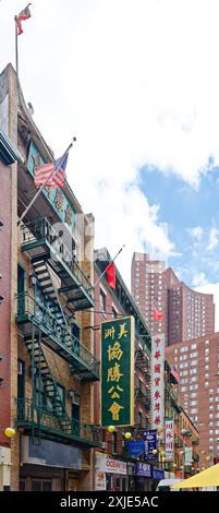 NYC Chinatown: Dueling flags – American, Taiwanese, and Chinese flags fly from neighboring buildings on narrow Pell Street, in the heart of Chinatown. Stock Photo