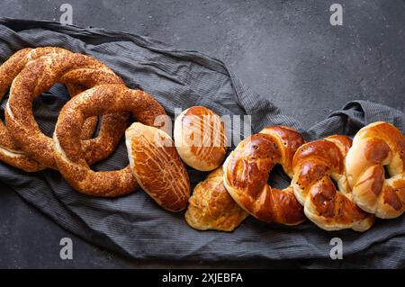 Traditional Turkish pastry concept, pogaca , bagel, on rustic table, famous bakery product Stock Photo