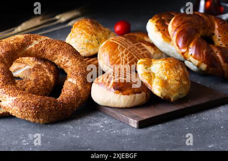 Traditional Turkish pastry concept, pogaca , bagel, on rustic table, famous bakery product Stock Photo