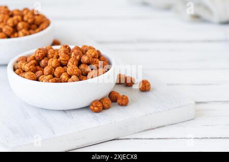 Roasted yellow chickpeas with chili pepper sauce, traditional spicy turkish nut, leblebi Stock Photo