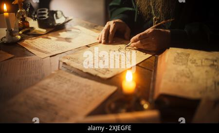 Close Up on Old Renaissance Male Hand Using Ink and Quill to Draw a Blueprint for a New Invention. Dedicated Inventor Working on an Innovative Creation, Writing Notes and Observations Stock Photo